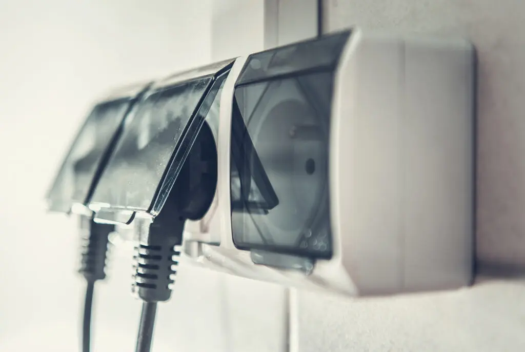 230 Volts European Electrical Wall Outlets with Two Cords Attached Closeup Photo.